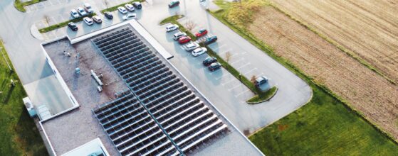 Aerial view of an industrial building with solar panels on the roof