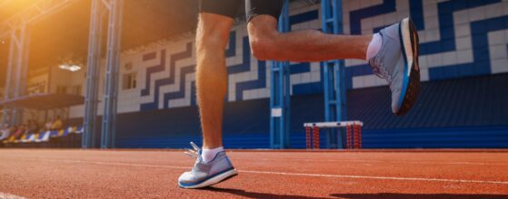 An athlete runs on the stadium track, enjoying the sunrise, embodying vitality and determination