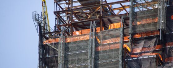 Construction site with crane and multi level commercial high rise building