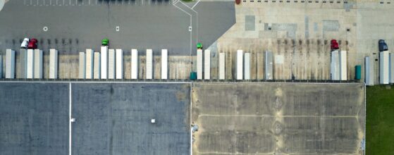 Large commercial distribution storehouse with many semitrucks unloading
